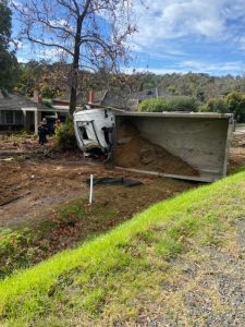 Truck rolls down embankment in Lilydale